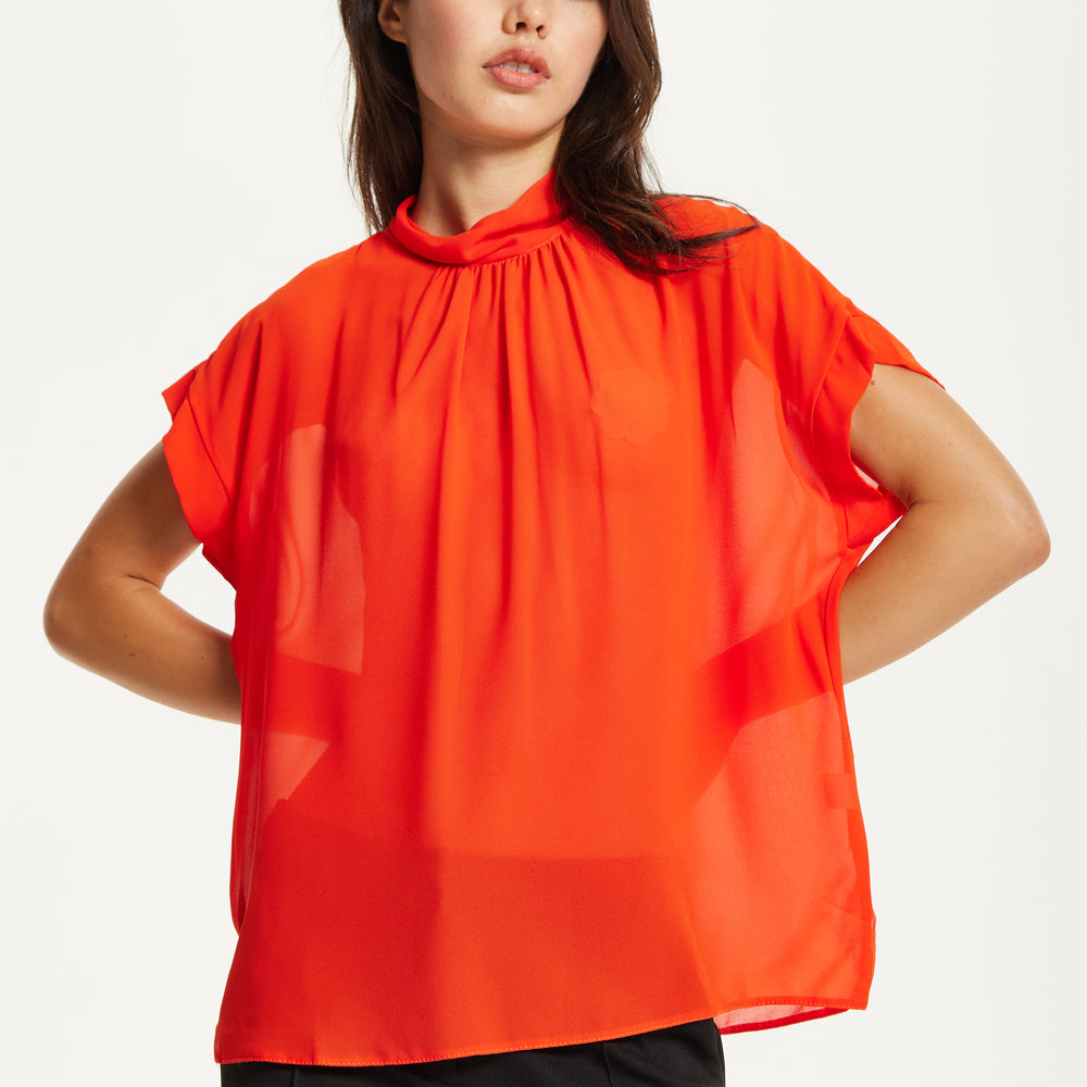 
                  
                    Orange High Neck Tie Back Top
                  
                