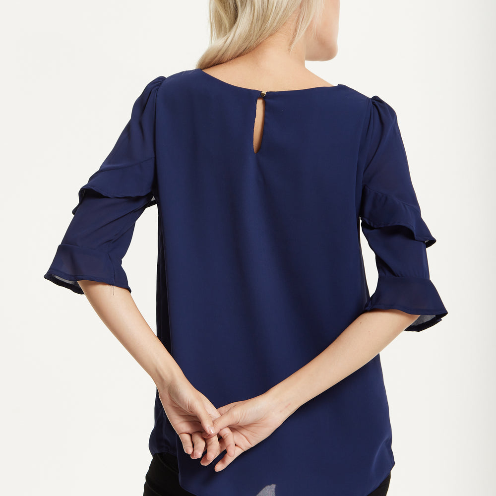 
                  
                    Navy Ruffle Sleeve Blouse
                  
                