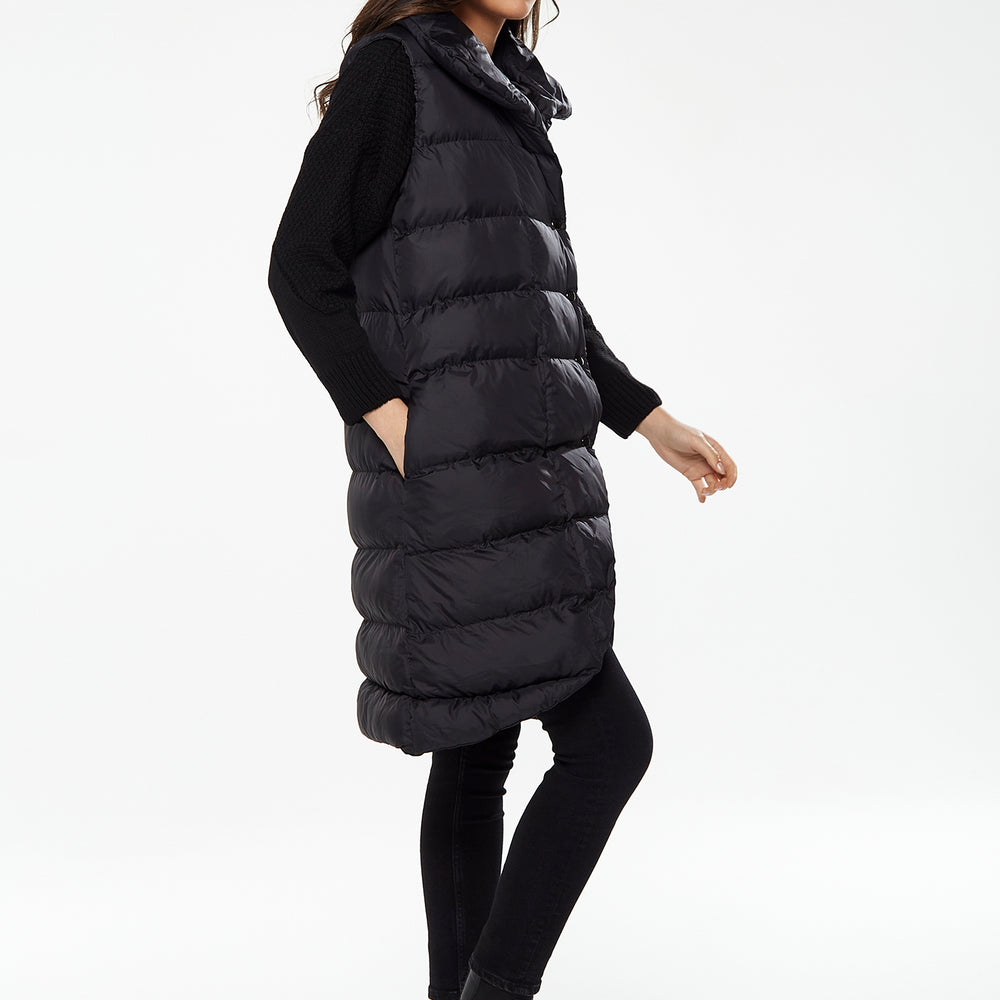 
                  
                    Women's Long Black Puffer Gilet with Asymmetric Button Closure, Drawstring High Neck, and Side Pockets for Ultimate Warmth
                  
                