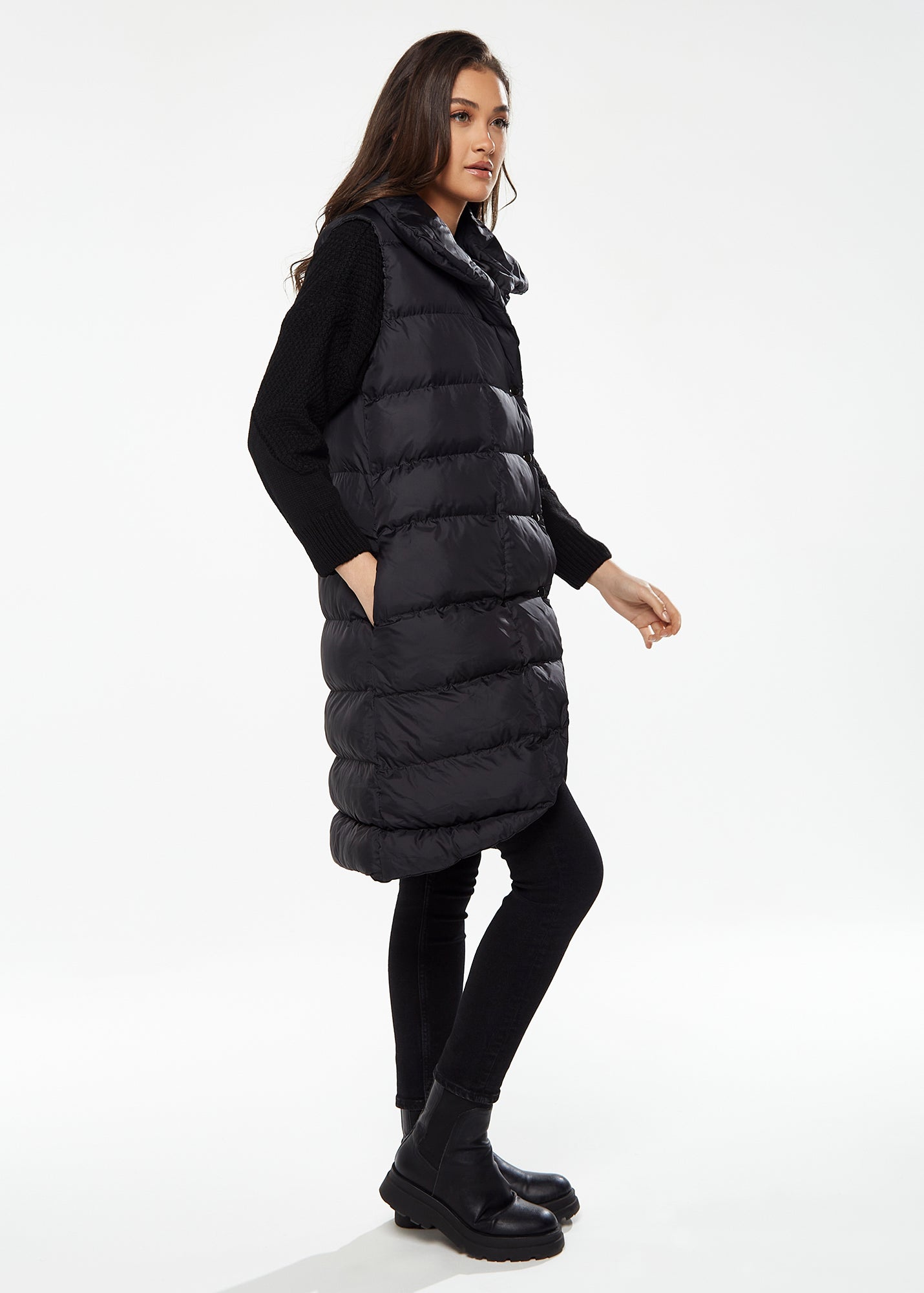 
                  
                    Women's Long Black Puffer Gilet with Asymmetric Button Closure, Drawstring High Neck, and Side Pockets for Ultimate Warmth
                  
                