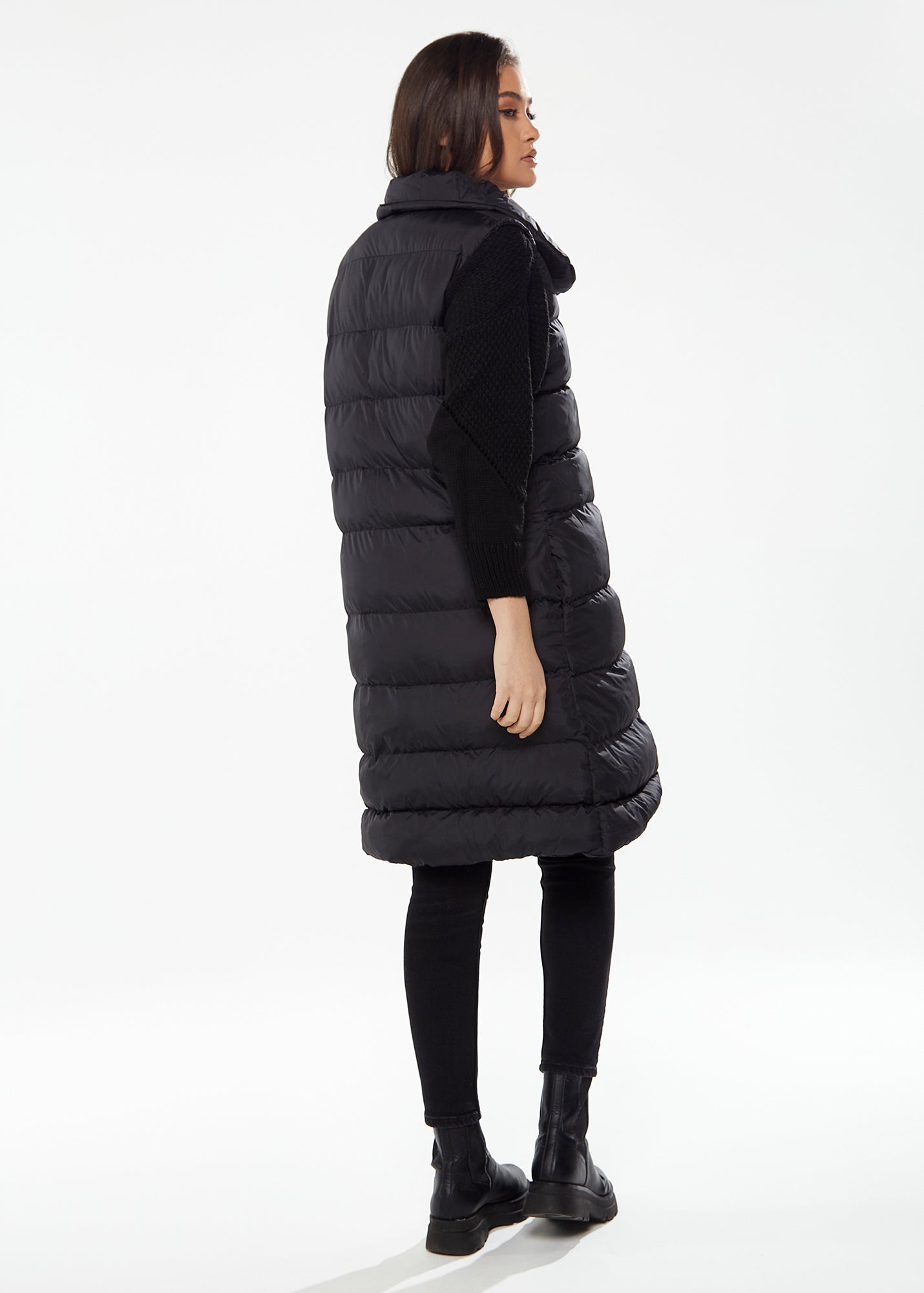 
                  
                    Women's Long Black Puffer Gilet with Asymmetric Button Closure, Drawstring High Neck, and Side Pockets for Ultimate Warmth
                  
                