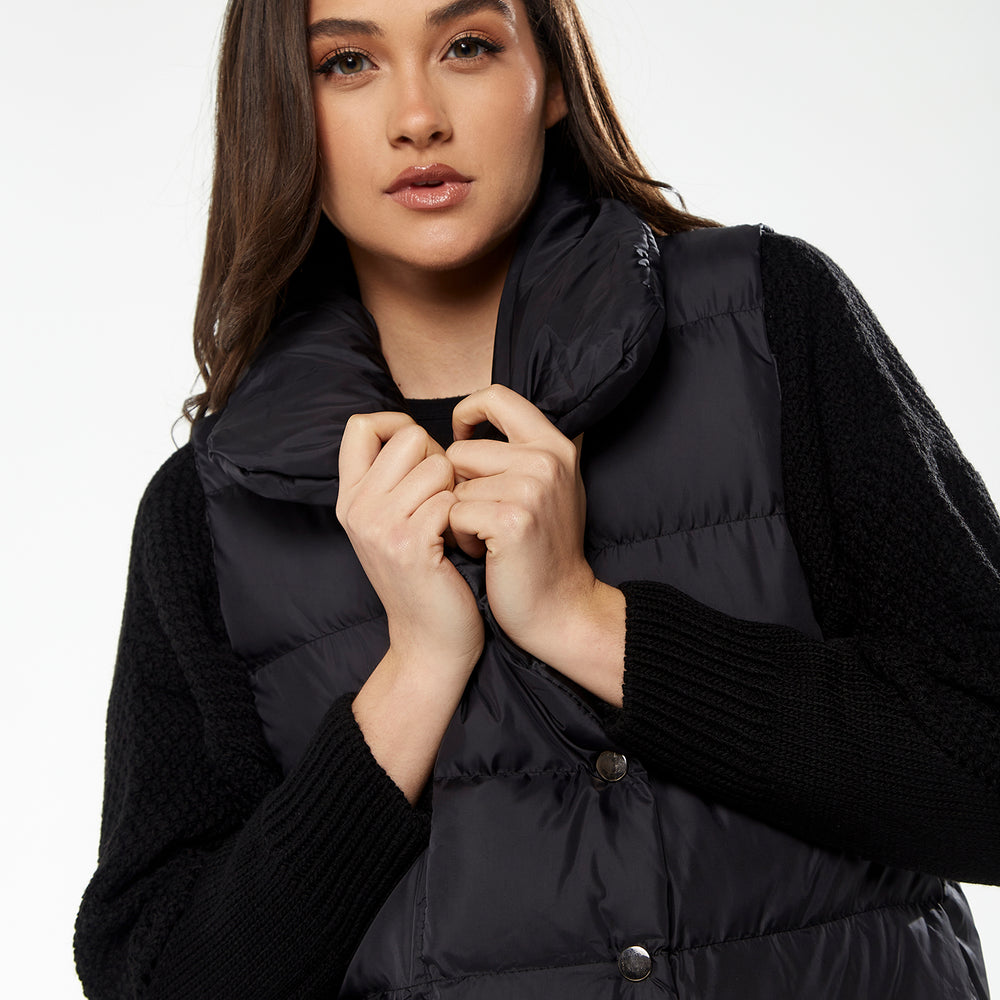 
                  
                    Women's Long Black Puffer Gilet with Asymmetric Button Closure, Drawstring High Neck, and Side Pockets for Ultimate Warmth
                  
                